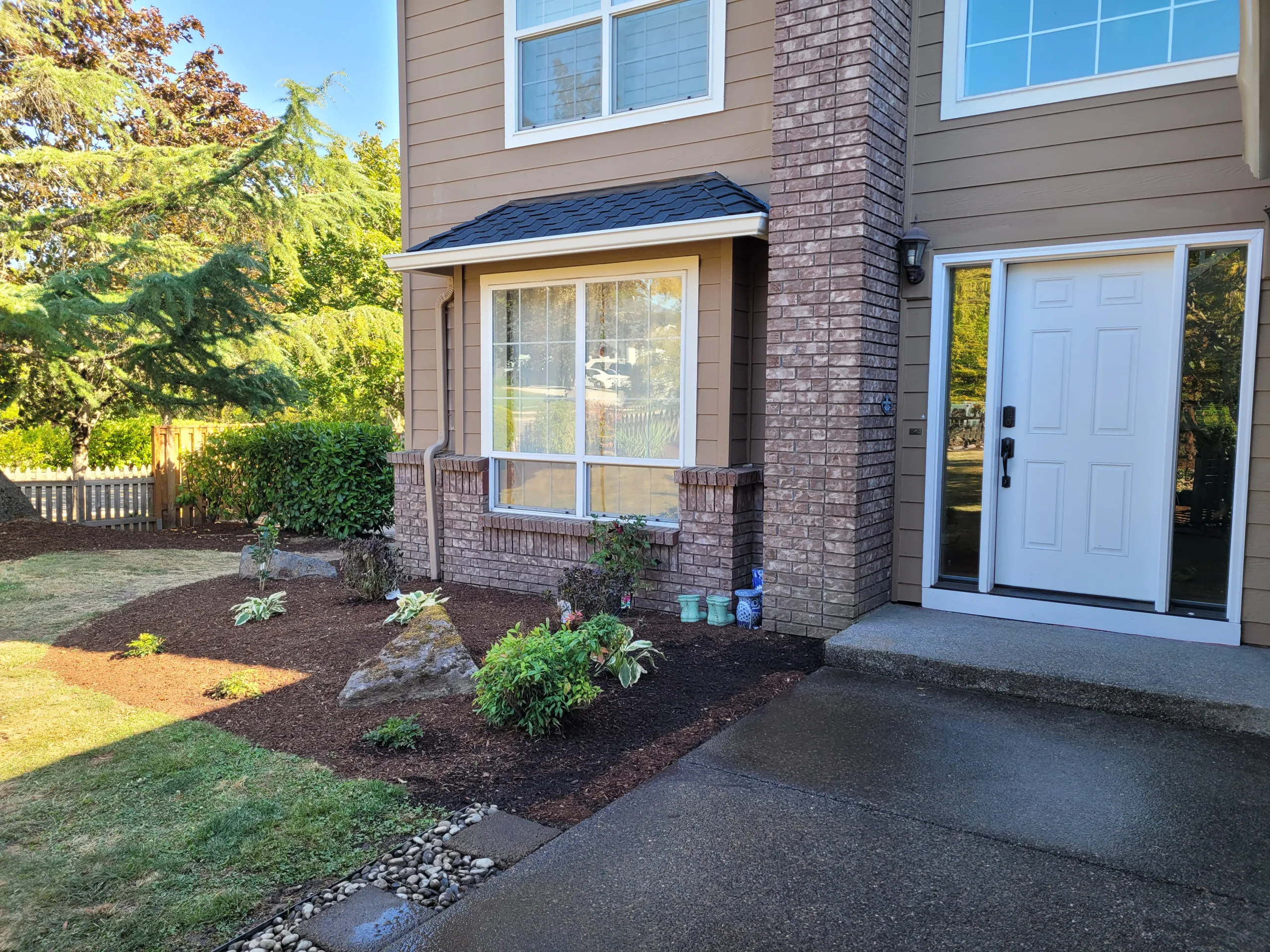 Completed paver patio with hardscape walkways in Portland backyard